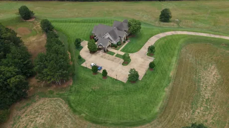 Aerial drone view of a large program property with mowed paths through the acreage