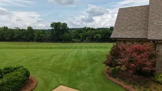 Aerial view of a large striped lawn maintained by H & H Lawn Care in Floyd County, Georgia