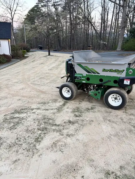 An Earth & Turf topdresser working a freshly sanded Northwest Georgia lawn